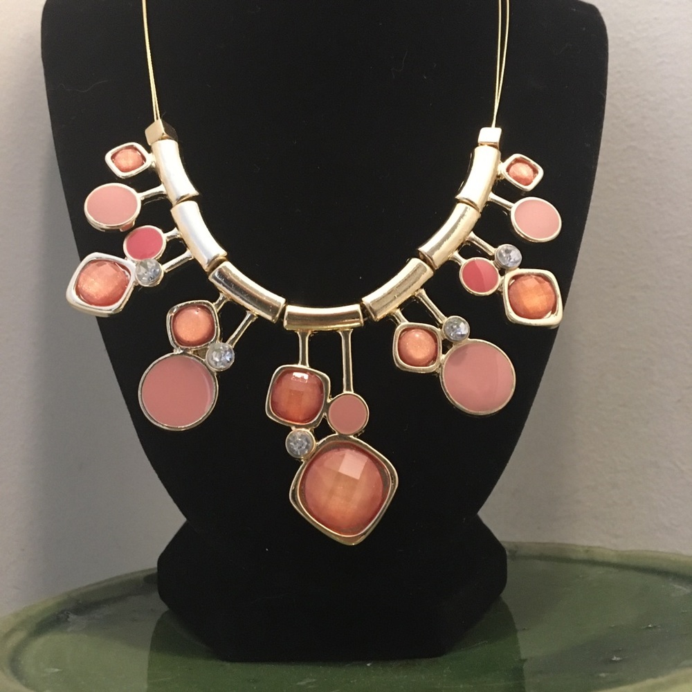 Gold toned and pink jewel statement necklace.